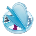 Round translucent plastic pill box with three compartments.