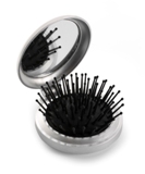 Plastic pocket mirror and brush.