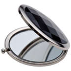 Compact mirror with black finish and a press button.